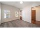 Bright bedroom featuring two windows, neutral carpet, and a classic paneled door at 136 Pelham St, Haw River, NC 27258