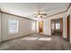 Bright bedroom features neutral walls, carpet, ceiling fan, and two windows at 136 Pelham St, Haw River, NC 27258