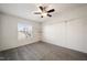 Bedroom with large window and ceiling fan has two shelves on the side wall at 136 Pelham St, Haw River, NC 27258