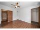 Bedroom features wood floors, ceiling fan, and a door leading to the bathroom at 136 Pelham St, Haw River, NC 27258