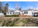 Charming home with black shutters, white siding and a manicured front lawn at 136 Pelham St, Haw River, NC 27258