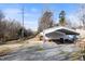 Gravel driveway leading to a carport attached to the house, near the garage at 136 Pelham St, Haw River, NC 27258