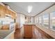 Kitchen with a center island, wood cabinets, white appliances, and ample counter space at 136 Pelham St, Haw River, NC 27258