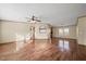 Spacious living room featuring wood floors, a ceiling fan, and plenty of natural light at 136 Pelham St, Haw River, NC 27258