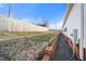 Well-maintained backyard featuring a wooden fence and gravel pathway at 136 Pelham St, Haw River, NC 27258