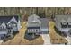Aerial view of a gray two-story home with a front porch and driveway at 143 Rossell Park Cir, Garner, NC 27529