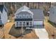 Aerial view of a gray two-story home with a covered front porch and garage at 143 Rossell Park Cir, Garner, NC 27529