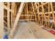 Unfinished attic space with exposed wood beams and plywood flooring at 143 Rossell Park Cir, Garner, NC 27529