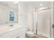 Bathroom featuring a marble vanity, framed mirror, toilet, and glass enclosed shower at 143 Rossell Park Cir, Garner, NC 27529