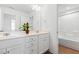 Bright bathroom with dual sinks and ample counter space on white cabinets at 143 Rossell Park Cir, Garner, NC 27529