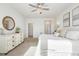 Bright bedroom features a chandelier fan, white walls, and plush carpeting at 143 Rossell Park Cir, Garner, NC 27529