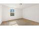 Bedroom featuring a neutral carpet, white walls, and a window at 143 Rossell Park Cir, Garner, NC 27529