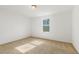 Cozy bedroom featuring a neutral carpet, white walls, and a window at 143 Rossell Park Cir, Garner, NC 27529