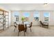 Bright dining room with a glass table, modern chairs, and neighborhood views at 143 Rossell Park Cir, Garner, NC 27529