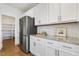 Well-organized kitchen counter with stainless steel refrigerator, white cabinets, and subway tile backsplash, providing ample storage at 143 Rossell Park Cir, Garner, NC 27529