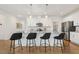 Elegant kitchen island featuring granite countertop, seating for four, and stylish pendant lighting, perfect for casual dining at 143 Rossell Park Cir, Garner, NC 27529