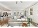 Open-concept living room with modern decor, hardwood floors, and view of the bright kitchen at 143 Rossell Park Cir, Garner, NC 27529