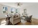 Bright living room with hardwood floors, neutral tones, and large windows offering wooded views at 143 Rossell Park Cir, Garner, NC 27529