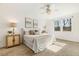 Bright main bedroom with carpet floor and a large window overlooking the wooded backyard at 143 Rossell Park Cir, Garner, NC 27529