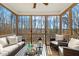 Inviting screened porch with comfortable seating, rustic decor, and wooded views at 143 Rossell Park Cir, Garner, NC 27529