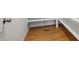 Walk in closet featuring wood floor and white shelves and base trim at 143 Rossell Park Cir, Garner, NC 27529
