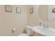 Half bathroom features a white toilet, sink, and framed art at 146 Skyros Loop, Cary, NC 27519