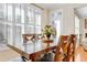 Dining area filled with natural light, showcasing a wooden table and seating for Gathering meals at 146 Skyros Loop, Cary, NC 27519