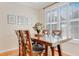 Inviting dining area with a large wooden table, seating for six, and bright natural lighting at 146 Skyros Loop, Cary, NC 27519
