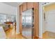 Kitchen with stainless steel refrigerator and ample wooden cabinet space near the living room at 146 Skyros Loop, Cary, NC 27519