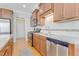 Well-lit kitchen featuring wooden cabinets, stainless steel appliances and light countertops at 146 Skyros Loop, Cary, NC 27519