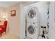 Compact laundry room showcasing stacked washer and dryer and a storage shelf at 146 Skyros Loop, Cary, NC 27519