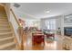 Bright living room features hardwood floors, a fireplace, and staircase access to the upper level at 146 Skyros Loop, Cary, NC 27519