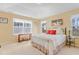 Bright main bedroom features multiple windows, a vaulted ceiling, and neutral decor at 146 Skyros Loop, Cary, NC 27519