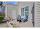Outdoor patio area features a white exterior and blue chairs at 146 Skyros Loop, Cary, NC 27519