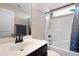 Cozy bathroom features modern vanity with dark hardware, shower with tub, and stylish shower curtain at 15 Mcdowell Pkwy, Clayton, NC 27520
