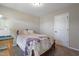 Cozy bedroom featuring queen bed with purple floral bedding and neutral walls with carpet flooring at 15 Mcdowell Pkwy, Clayton, NC 27520