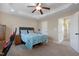 Comfortable bedroom features tray ceilings, a ceiling fan, natural lighting, and a queen-size bed at 15 Mcdowell Pkwy, Clayton, NC 27520