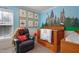 ' bedroom featuring Harry Potter decor, a crib, a gray leather recliner, and ample natural light at 15 Mcdowell Pkwy, Clayton, NC 27520