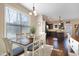 Sunlit dining area featuring a wooden table and a view of the open-concept kitchen at 15 Mcdowell Pkwy, Clayton, NC 27520