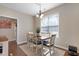 Inviting dining area with a wooden table, seating for six, and natural light from a large window at 15 Mcdowell Pkwy, Clayton, NC 27520