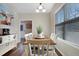 Bright dining area with seating for six, a side table with coffee maker, and hardwood floors at 15 Mcdowell Pkwy, Clayton, NC 27520