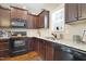 Spacious kitchen with stainless steel appliances, dark wood cabinets, and granite countertops at 15 Mcdowell Pkwy, Clayton, NC 27520