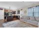 Open living room features a modern gray sofa, dark hardwood flooring, and seamlessly connects to the kitchen at 15 Mcdowell Pkwy, Clayton, NC 27520