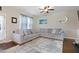 Inviting living room showcasing a large sectional sofa, stylish decor, and a ceiling fan at 15 Mcdowell Pkwy, Clayton, NC 27520