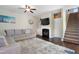Comfortable living room featuring a fireplace, a large sectional sofa, and ample natural light at 15 Mcdowell Pkwy, Clayton, NC 27520
