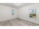 Bedroom featuring two windows, carpet, and neutral colors at 171 Piney Field Rd, Fuquay Varina, NC 27526