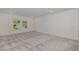A spacious bedroom with neutral gray carpet and a window providing natural light at 171 Piney Field Rd, Fuquay Varina, NC 27526