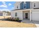 Close-up view of a home's front entrance, showing door, sidelight, and landscaping at 171 Piney Field Rd, Fuquay Varina, NC 27526