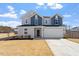 Two-story home with a two-car garage and a well-maintained lawn in a suburban neighborhood at 171 Piney Field Rd, Fuquay Varina, NC 27526