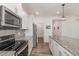 Modern kitchen featuring granite countertops, stainless steel appliances, and stylish pendant lighting at 171 Piney Field Rd, Fuquay Varina, NC 27526